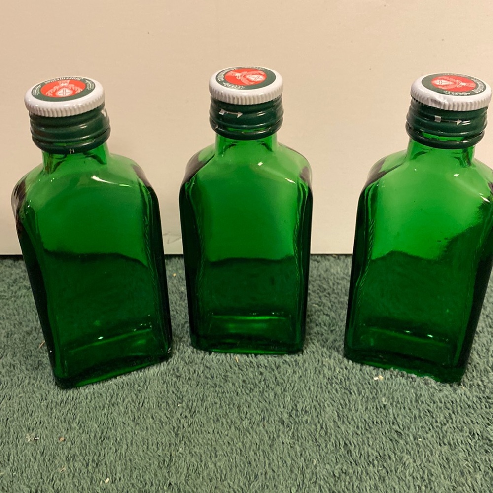 Set of three Jäegermeister green bottles with caps